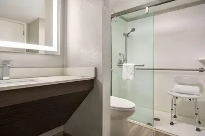 a bathroom with a toilet and a glass shower at La Quinta Inn Lexington-Horse Park in Lexington