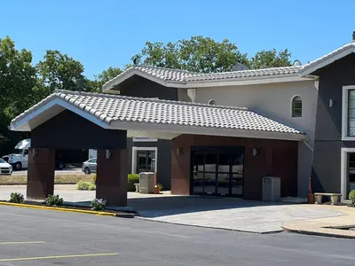 a building with a parking lot with a garage at La Quinta Inn Lexington-Horse Park in Lexington