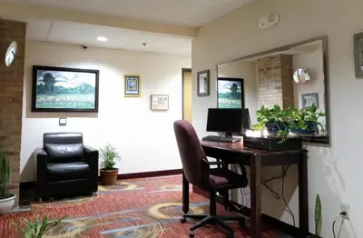 a office with a desk with a computer and a chair at Country Hearth Inn & Suites - Kenton in Kenton