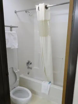 a white bathroom with a toilet and a shower at Country Hearth Inn & Suites - Kenton in Kenton