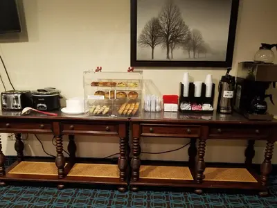 a wooden table with a bunch of donuts on it at Country Hearth Inn & Suites - Kenton in Kenton