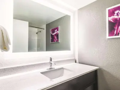 a bathroom with a sink and a mirror at La Quinta by Wyndham Cincinnati Sharonville in Sharonville