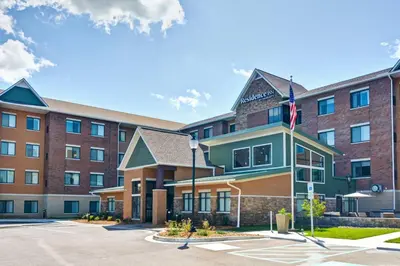 an exterior view of a hotel with an american flag at Residence Inn by Marriott Cleveland Airport/Middleburg Heights in Middleburg Heights