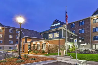 a hotel with a flag in front of a building at Residence Inn by Marriott Cleveland Airport/Middleburg Heights in Middleburg Heights