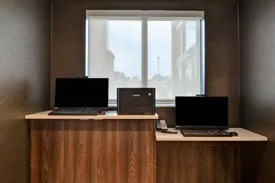 two laptops sitting on a desk with a window at Residence Inn by Marriott Cleveland Airport/Middleburg Heights in Middleburg Heights