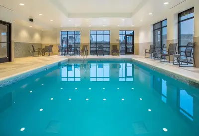 a swimming pool with blue water in a building at Hampton Inn & Suites Newport/Cincinnati, KY in Newport