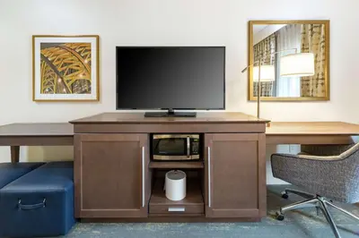 a hotel room with a desk with a tv and a computer at Hampton Inn & Suites Newport/Cincinnati, KY in Newport