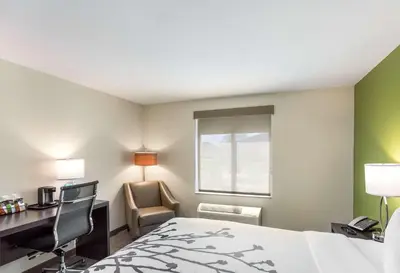 a hotel room with a bed and a desk and a computer at Sleep Inn Logan Ohio-Hocking Hills in Logan