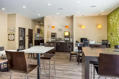 a restaurant with tables and chairs and a cafeteria at Sleep Inn Logan Ohio-Hocking Hills in Logan