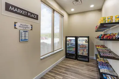 a martini place store with a window and shelves of food at MainStay Suites Logan Ohio-Hocking Hills in Logan