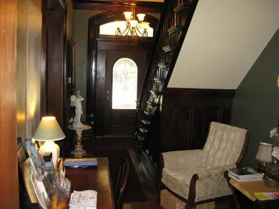 a living room with a chair and a table at Bayberry House Bed and Breakfast in Steubenville