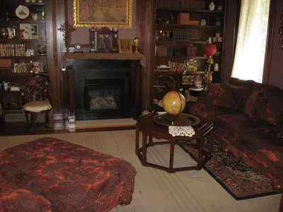 a living room with a couch and a fireplace at Bayberry House Bed and Breakfast in Steubenville