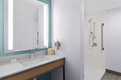 a bathroom with a sink and a shower at Hilton Garden Inn Lexington Georgetown in Georgetown