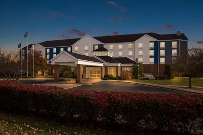 a large white building with blue windows and a street at Hilton Garden Inn Lexington Georgetown in Georgetown