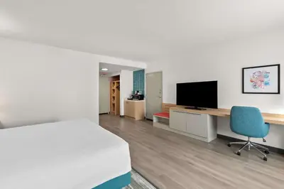a bedroom with a bed and a desk and a television at Hilton Garden Inn Lexington Georgetown in Georgetown