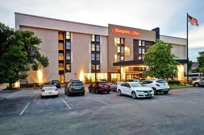 a hotel with cars parked in a parking lot at Hampton Inn Lexington I-75 in Lexington