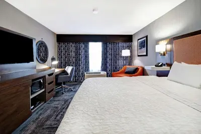 a hotel room with a large bed and a television at Hampton Inn Lexington I-75 in Lexington