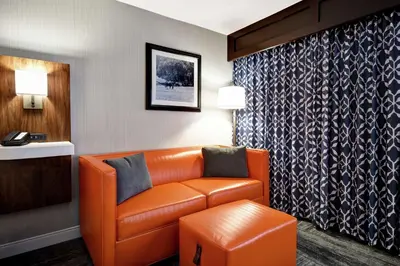 an orange leather couch in a hotel room at Hampton Inn Lexington I-75 in Lexington