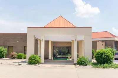 a brick building with a white and orange roof at Super 8 by Wyndham Harrison OH in Harrison