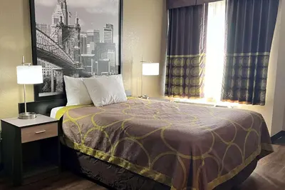 a hotel room with a bed and a window at Super 8 by Wyndham Harrison OH in Harrison