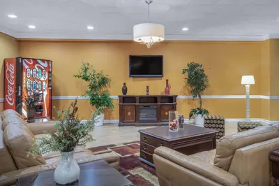 a living room with couches and a flat screen tv at Super 8 by Wyndham Harrison OH in Harrison