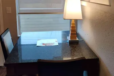 a table with a lamp and a book on it at Baymont Inn and Suites by Wyndham Columbus / Near OSU in Columbus