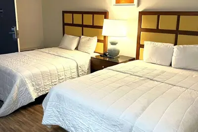 a hotel room with two beds and a lamp at Baymont Inn and Suites by Wyndham Columbus / Near OSU in Columbus