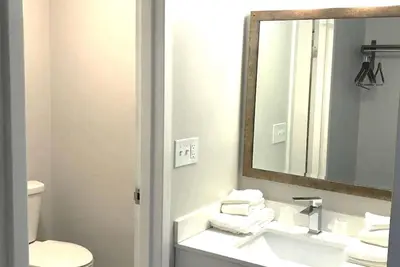 a bathroom with a sink and a mirror and a toilet at Baymont Inn and Suites by Wyndham Columbus / Near OSU in Columbus