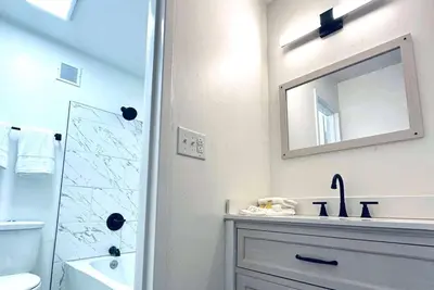 a white bathroom with a sink and a mirror at Baymont Inn and Suites by Wyndham Columbus / Near OSU in Columbus