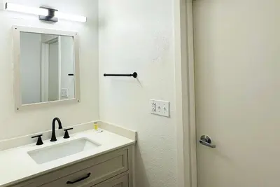 a bathroom with a sink and a mirror at Baymont Inn and Suites by Wyndham Columbus / Near OSU in Columbus