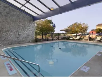 a large empty swimming pool in a building at Days Inn by Wyndham Kent - Akron in Kent