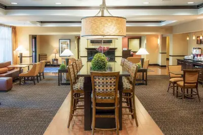 a dining room and living room with a table and chairs at Hampton Inn Oxford/Miami University Area in Oxford