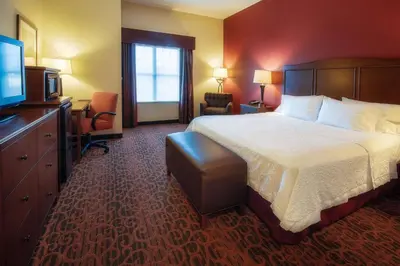 a hotel room with a bed and a flat screen tv at Hampton Inn Oxford/Miami University Area in Oxford