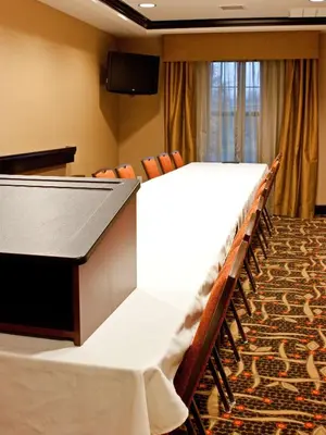 a conference room with a table and chairs and a podium at Hampton Inn Oxford/Miami University Area in Oxford