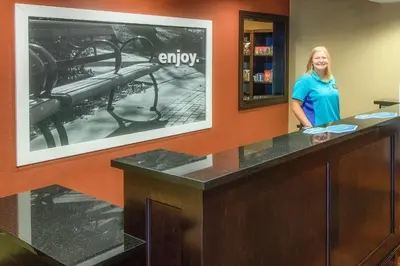 a woman standing at a desk in a office at Hampton Inn Oxford/Miami University Area in Oxford