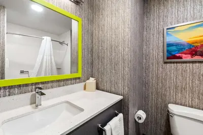 a bathroom with a white sink and a yellow mirror at Hampton Inn Lexington - Georgetown I-75 in Georgetown