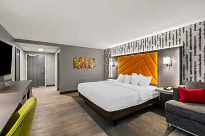 a hotel room with a large bed and a couch at Hampton Inn Lexington - Georgetown I-75 in Georgetown