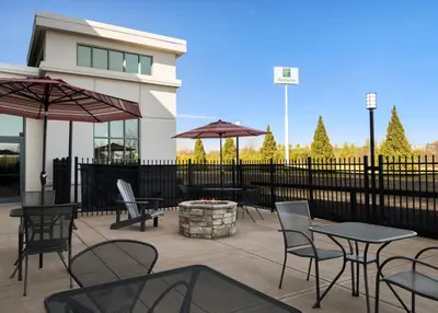 a patio with tables and chairs and a fire pit at Holiday Inn - Cincinnati - Liberty Way by IHG in West Chester