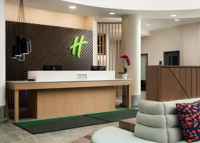 a lobby with a reception desk and a chair at Holiday Inn - Cincinnati - Liberty Way by IHG in West Chester