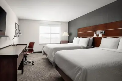 a hotel room with two beds and a desk at Holiday Inn - Cincinnati - Liberty Way by IHG in West Chester