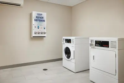 a washing machine and a washer in a room at Holiday Inn Express and Suites Wheeling by IHG in Triadelphia