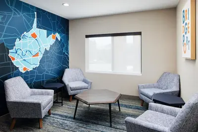 a waiting room at a hospital with chairs and a table at Holiday Inn Express and Suites Wheeling by IHG in Triadelphia