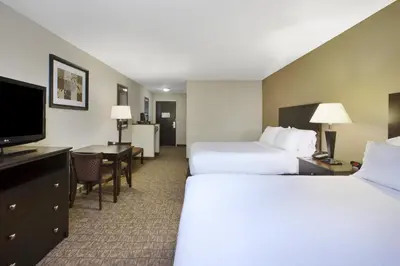 a hotel room with two beds and a flat screen tv at Holiday Inn Express and Suites Wheeling by IHG in Triadelphia