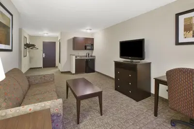 a living room with a couch and a flat screen tv at Holiday Inn Express and Suites Wheeling by IHG in Triadelphia