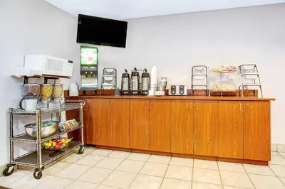 a kitchen with a wooden counter with a tv at Microtel Inn & Suites by Wyndham Mason in Mason