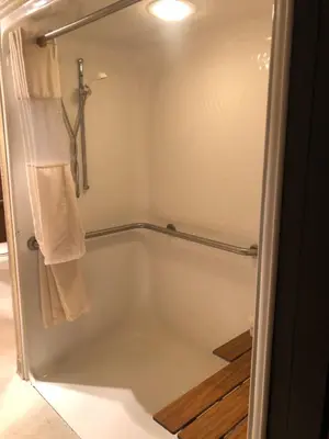 a bathroom with a shower with a tub at Microtel Inn & Suites by Wyndham Mason in Mason