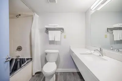 a white bathroom with a toilet and a sink at Motel 6 - Franklin, OH in Franklin