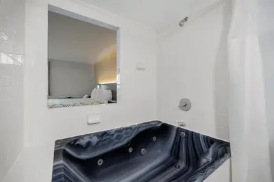 a bathroom with a black sink and a mirror at Motel 6 - Franklin, OH in Franklin