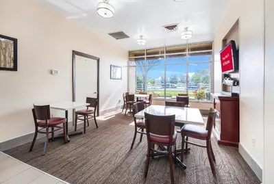 a dining room with tables and chairs and a window at Red Roof Inn Columbus - Grove City in Grove City