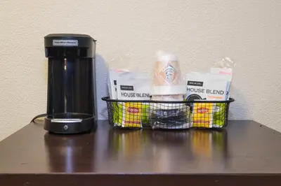 a coffee maker and a basket on a table at Red Roof Inn PLUS+ Columbus Downtown - Convention Center in Columbus